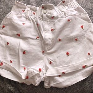 White shorts with detailed roses.